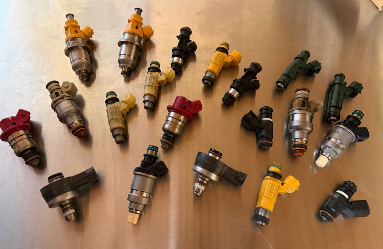 A bench of customer marine fuel injectors — every engine family